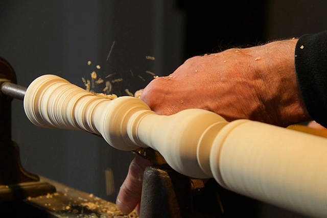 Artisan turning wood on lathe