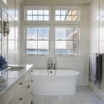 Beautiful soaking tub in bathroom with bright light and large windows