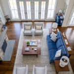 Overhead view of living room with chairs, sofa, coffee table, fireplace, and tall windows