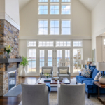 Living room with ocean view. Chairs, chaise, coffee table, rug, fireplace, lamps