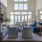 Living room with ocean view. Chairs, chaise, coffee table, rug, fireplace, lamps