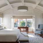 Bedroom with coffered ceiling and chandelier