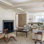 Sitting room with fireplace, modern chair, sofa and coffee table