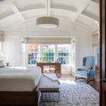 Bedroom with coffered ceiling and chandelier