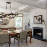 Dining room with fireplace, artwork, table, chairs and modern funky overhead light